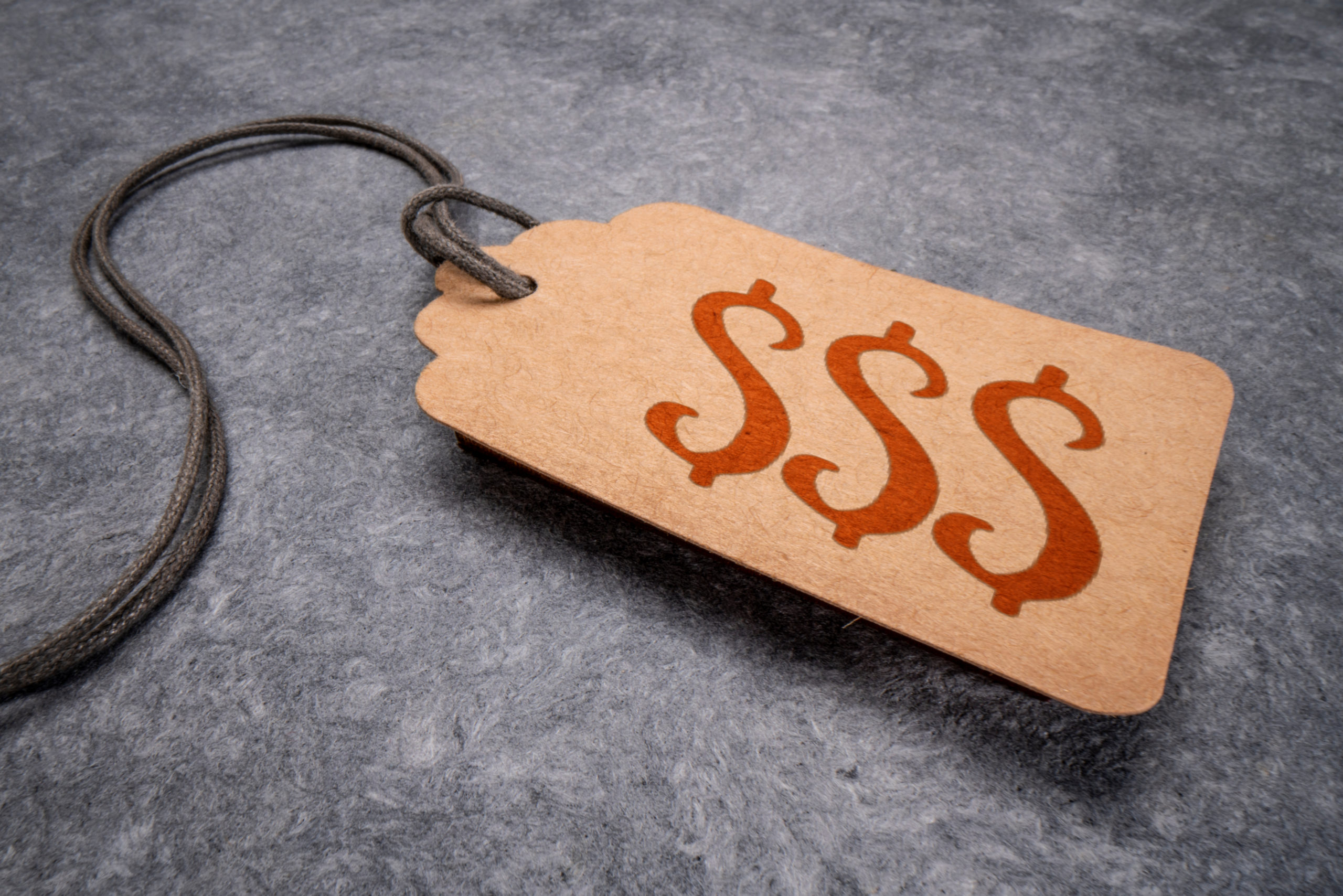 Price tag with money ($$$) symbols on it.